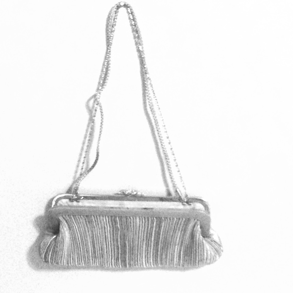 "SALE " VINTAGE NEW SILVER CLUTCH BAG WITH STRAPS.